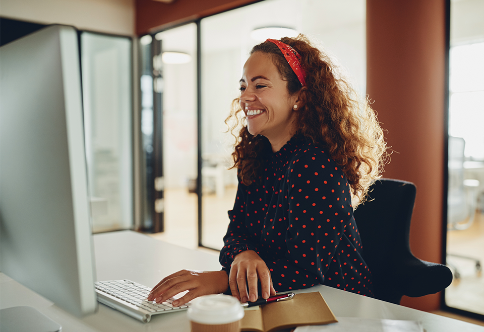 A woman sitting at a computer in her office