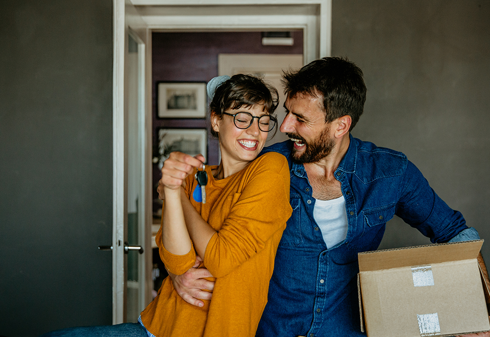 A couple is happily dancing in their kitchen