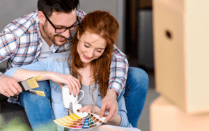 A man and woman are looking at color swatches