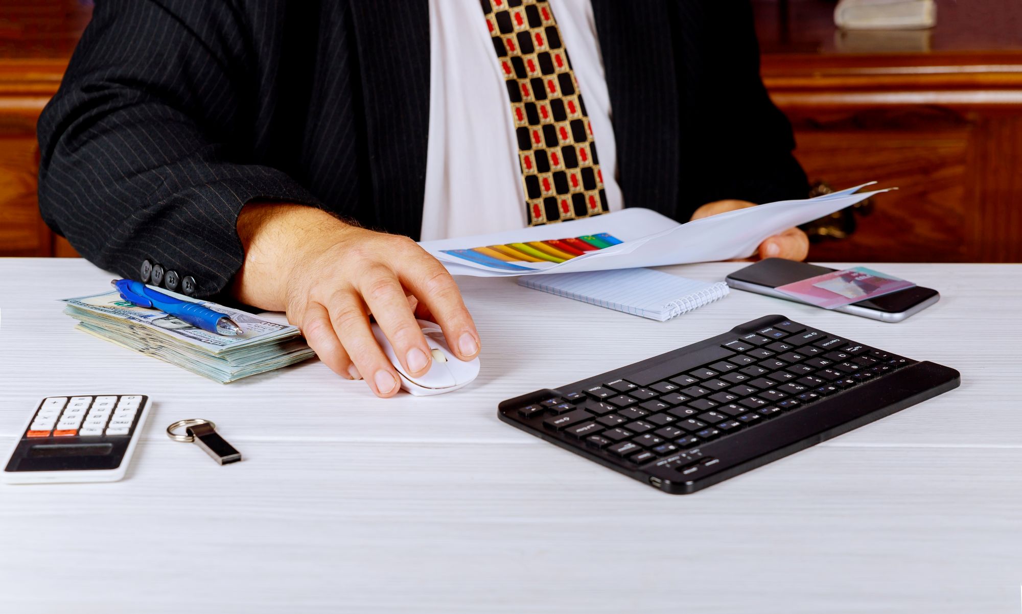 Business man sitting at a desk working on finances