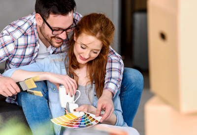 A man and woman are looking at color swatches