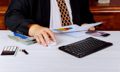 Business man sitting at a desk working on finances